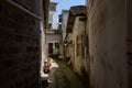 Shady blind alley between aged dwelling buildings