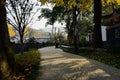 Shady fenced path in city of sunny winter morning