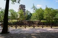 Shady fenced riverside in sunny autumn with sightseeing tower across river