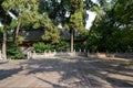 Shady flagstone courtyard before ancient Chinese building in aft Royalty Free Stock Photo