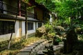 Shady flagstone path before Chinese traditional buildings in sun Royalty Free Stock Photo