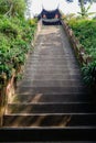 Shady hillsdie steep steps before ancient Chinese tower on sunny Royalty Free Stock Photo