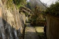 Shady hillside path in ancient dwelling buildings