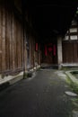 Shady lichen-covered path under eaves of ancient Chinese wooden Royalty Free Stock Photo