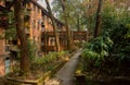 Shady path before aged red brick apartment building of 1970s