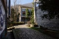 Shady path between newly built traditional dwelling buildings of small town