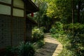 Shady planked path outside Chinese traditional houses in sunny a
