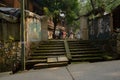 Shady roadside stairway at gate of old dwelling building of 1970s