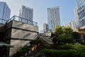 Shady stairway before modern buildings in sunny city