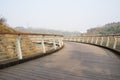 Shady waterside fenced and planked footbridge in sunny winter af