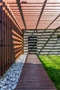 Shady wooden path to stone house