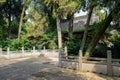 Shady yard with balustrade before ancient Chinese building in woods Royalty Free Stock Photo