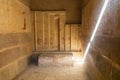 Shaft of light illuminating the interior of a temple with hieroglyphs at the Saqqara Necropolis Royalty Free Stock Photo