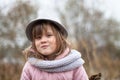 Shaggy girl in jacket, gray scarf and fedora hat