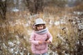 Shaggy girl in jacket, gray scarf and fedora hat