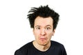 Shaggy young guy with long hair surprised with open mouth on a white isolated background