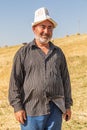 Man wearing a traditional hat in a field during harvest