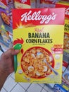 SHAH ALAM, MALAYSIA - 18 September 2020 : Hand hold a boxed of KELLOGGS Banana Corn Flakes breakfast for sell in the supermarket. Royalty Free Stock Photo