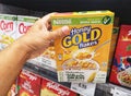 SHAH ALAM, MALAYSIA - 18 September 2020 : Hand hold a boxed of NESTLE Honey Gold Flakes for sell in the supermarket.