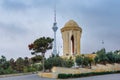 Shahidlar Monument or Eternal flame Monument on Martyrs` Lane. And Tv tower in the evening. Baku. Azerbaijan