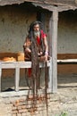 Shaiva sadhu seeking alms in front of a temple