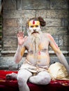 Shaiva sadhu seeks alms on the Pashupatinath Temple in Kathmandu