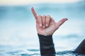 Shaka, surf and man in ocean with hand sign outdoor in nature while on vacation in Australia. Surfing culture, hang Royalty Free Stock Photo