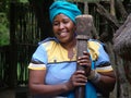 SHAKALAND, SOUTH AFRICA - CIRCA NOVEMBER 2011: Unidentified Zulu woman holding traditional wooden pestle