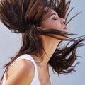 Shake it all about. Closeup shot of a beautiful young woman flinging her brunette hair.