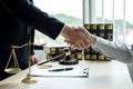 Shake hand Professional man lawyers work at a law office There are scales, Scales of justice, judges gavel, and litigation