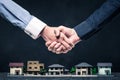 Shake hands on a miniature model house Royalty Free Stock Photo