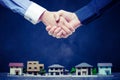 Shake hands on a miniature model house Royalty Free Stock Photo