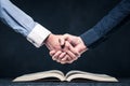 Shake hands on open books Royalty Free Stock Photo