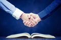 Shake hands on open books Royalty Free Stock Photo