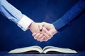 Shake hands on open books Royalty Free Stock Photo