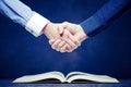 Shake hands on open books Royalty Free Stock Photo