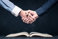 Shake hands on open books Royalty Free Stock Photo