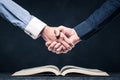 Shake hands on open books Royalty Free Stock Photo