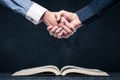 Shake hands on open books Royalty Free Stock Photo