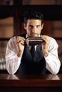 Shaken, not stirred. A handsome young bartender mixing a cocktail. Royalty Free Stock Photo