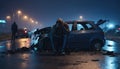 A shaken person involved in a car accident sits at the scene of the accident and is distraught