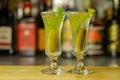 Shaken vodka and pickle juice with ice in shot glass and garnishing with small pickled cucumber and dill Royalty Free Stock Photo