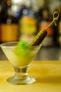 Shaken vodka and pickle juice with ice in shot glass and garnishing with small pickled cucumber and dill Royalty Free Stock Photo