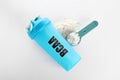 Shaker with abbreviation BCAA Branched-chain amino acid and powder on white background, flat lay