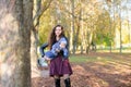 Shakes the baby in her arms. Charming little boy with rose cheeks smiles while mother holds him in her arms Royalty Free Stock Photo