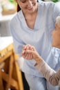 Thankful aged woman shaking hand of caregiver Royalty Free Stock Photo