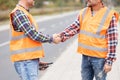 shaking hand on the road construction field Royalty Free Stock Photo