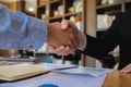 Shaking hands with a business agreement that is exchanged or successful