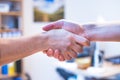 Shaking hands, concept for teamwork: Close up of man and woman shaking hands in the office Royalty Free Stock Photo