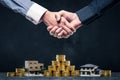 Shaking hands with save money and home Royalty Free Stock Photo